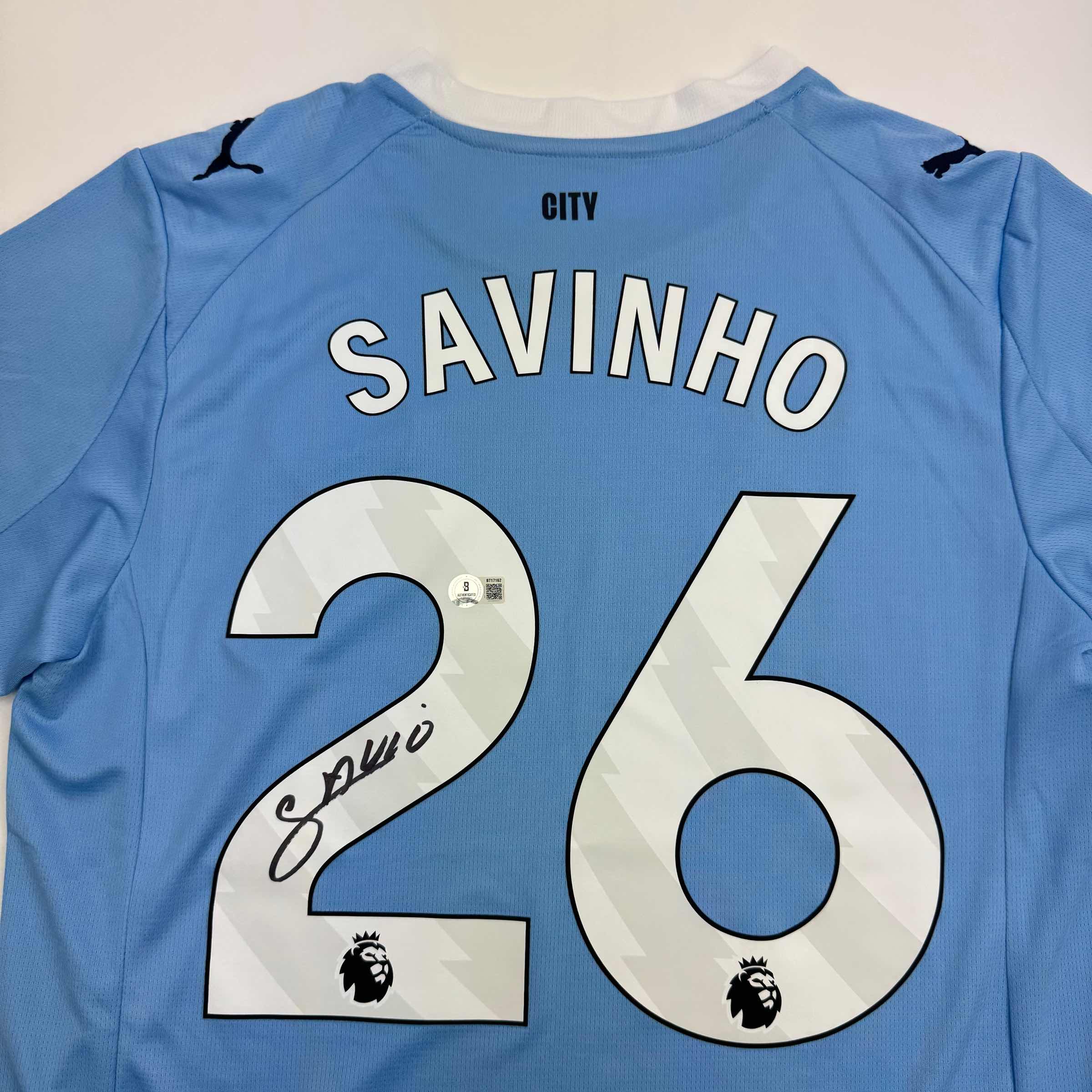 Autographed/Signed Savinho Manchester City Blue Soccer Futbol Jersey Beckett BAS COA